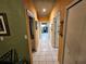 Hallway with white-tiled floor and multiple doors in a home at 306 Aylesbury Ct, Kissimmee, FL 34758
