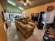 Spacious living room featuring tile floors and neutral-colored furniture at 306 Aylesbury Ct, Kissimmee, FL 34758