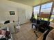 Enclosed patio with neutral tiling, door to the backyard, and some furniture at 306 Aylesbury Ct, Kissimmee, FL 34758