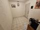 Utility room featuring tile flooring, storage shelving and access to the exterior at 306 Aylesbury Ct, Kissimmee, FL 34758
