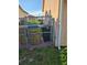 Outdoor side yard utility area featuring trash and recycling bins, kept neatly at 306 Aylesbury Ct, Kissimmee, FL 34758