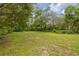 Expansive backyard featuring lush green grass and ample space for outdoor activities or potential landscaping projects at 32125 Okaloosa Trl, Sorrento, FL 32776