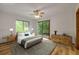 Staged bedroom with ample light, ceiling fan, and outdoor access at 32125 Okaloosa Trl, Sorrento, FL 32776