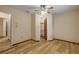 Bedroom featuring hardwood floors, ceiling fan, closet, and access to an additional room at 32125 Okaloosa Trl, Sorrento, FL 32776