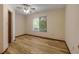 Bright bedroom with hardwood floors, ceiling fan, and natural light streaming through the window at 32125 Okaloosa Trl, Sorrento, FL 32776