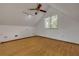 Vaulted bedroom features wood floors, a ceiling fan, and a large window at 32125 Okaloosa Trl, Sorrento, FL 32776