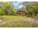 Stunning exterior view of this home with mature trees and landscaping, adding to its curb appeal and natural setting at 32125 Okaloosa Trl, Sorrento, FL 32776