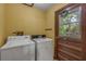 A laundry room with both a washer and dryer at 32125 Okaloosa Trl, Sorrento, FL 32776