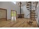 Living room featuring a spiral staircase, wood burning stove, and a loft at 32125 Okaloosa Trl, Sorrento, FL 32776