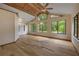 Spacious living room featuring wood floors, high ceilings, and large windows at 32125 Okaloosa Trl, Sorrento, FL 32776