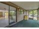 Enclosed porch featuring sliding glass doors, a window, and a view of the backyard at 32125 Okaloosa Trl, Sorrento, FL 32776