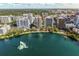 Aerial view of a city skyline along the water with a fountain and lush green space at 322 E Central Blvd # 1412, Orlando, FL 32801