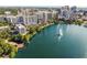 Picturesque aerial view of a sparkling lake and skyline showcasing an urban oasis with lush greenery and modern buildings at 322 E Central Blvd # 1412, Orlando, FL 32801