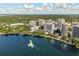 Panoramic aerial view of a stunning lake with a fountain, surrounded by lush greenery and modern buildings at 322 E Central Blvd # 1412, Orlando, FL 32801