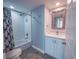 Updated bathroom with a tub and shower combination, white vanity, and a decorative mirror at 322 E Central Blvd # 1412, Orlando, FL 32801