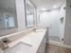 Modern bathroom with double vanity, quartz countertops, and a glass-enclosed shower at 322 E Central Blvd # 1412, Orlando, FL 32801
