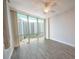 Well-lit bedroom featuring wood-look tile floors and a large window with a high-rise building view at 322 E Central Blvd # 1412, Orlando, FL 32801