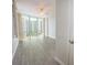 Bright bedroom with wood-look tile floors and a large window offering city views at 322 E Central Blvd # 1412, Orlando, FL 32801