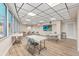 A meeting room with tables, chairs and a television screen displaying an image of a beach at 322 E Central Blvd # 1412, Orlando, FL 32801