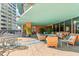 A luxurious outdoor patio features lounge seating, plants, and beautiful building views at 322 E Central Blvd # 1412, Orlando, FL 32801