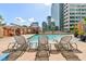 Upscale condo building features a community pool with city views and lounge chairs at 322 E Central Blvd # 1412, Orlando, FL 32801