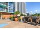 Building roof deck with BBQ grills, potted plants, and a seating area for entertaining guests at 322 E Central Blvd # 1412, Orlando, FL 32801
