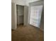 Bedroom features a bright window and a closet at 415 Wymore Rd # 101, Altamonte Springs, FL 32714
