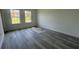 Bright bedroom with two windows and sleek gray wood-look flooring at 482 Marion Oaks Mnr, Ocala, FL 34473