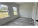 Bedroom with gray wood-look flooring and neutral paint at 482 Marion Oaks Mnr, Ocala, FL 34473