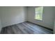 Bedroom with gray wood-look flooring and a single window at 482 Marion Oaks Mnr, Ocala, FL 34473