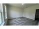 Bedroom with gray wood-look flooring and two windows at 482 Marion Oaks Mnr, Ocala, FL 34473