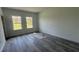 Bright bedroom with two windows and sleek gray wood-look flooring at 482 Marion Oaks Mnr, Ocala, FL 34473