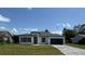 Beautiful single-story home with a modern aesthetic, featuring a garage and landscaped front yard at 482 Marion Oaks Mnr, Ocala, FL 34473