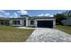 Well-maintained home featuring a two-car garage, updated facade, and inviting curb appeal at 482 Marion Oaks Mnr, Ocala, FL 34473