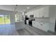 Bright and airy kitchen with a center island, stainless steel appliances, and sleek white cabinets at 482 Marion Oaks Mnr, Ocala, FL 34473