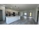 Open-concept kitchen with white cabinets, stainless appliances, quartz counters, and a large island at 482 Marion Oaks Mnr, Ocala, FL 34473