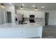 Stylish kitchen with stainless steel appliances, quartz countertops, and an island with a sink at 482 Marion Oaks Mnr, Ocala, FL 34473