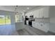 Contemporary kitchen equipped with an island, stainless steel appliances, and pristine white cabinetry at 482 Marion Oaks Mnr, Ocala, FL 34473