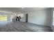 Expansive living area featuring light gray flooring and a seamless flow into the kitchen at 482 Marion Oaks Mnr, Ocala, FL 34473