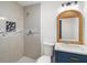 Bright bathroom featuring marbled tile shower, updated vanity, and new fixtures at 4925 Catfish Rd, Lake Wales, FL 33898