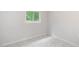 Bright bedroom featuring a window, modern marble-patterned tile flooring, and neutral wall paint at 4925 Catfish Rd, Lake Wales, FL 33898