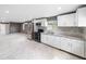 Modern kitchen with stainless steel appliances, tile backsplash, and white cabinets with eat in space at 4925 Catfish Rd, Lake Wales, FL 33898
