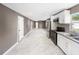 Bright kitchen featuring stainless steel appliances, white cabinets, granite counters and marble floors at 4925 Catfish Rd, Lake Wales, FL 33898