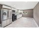 Kitchen featuring stainless steel appliances, white cabinetry, and ample counter space with tile floors at 4925 Catfish Rd, Lake Wales, FL 33898