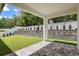 Covered patio overlooking landscaped backyard with retaining wall and privacy fence at 523 Sanctuary Golf Pl, Apopka, FL 32712