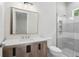 Modern bathroom featuring a rustic vanity, shower, and a large mirror at 523 Sanctuary Golf Pl, Apopka, FL 32712