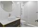 Modern bathroom boasts vessel sink, glass enclosed shower, and gray and white tiles at 523 Sanctuary Golf Pl, Apopka, FL 32712