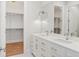 Luxurious bathroom featuring double sinks, quartz countertops, and a walk-in closet at 523 Sanctuary Golf Pl, Apopka, FL 32712