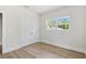 Bedroom featuring hardwood floors, large window, and spacious closet doors at 523 Sanctuary Golf Pl, Apopka, FL 32712