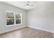 Cozy bedroom with ceiling fan and large window offering natural light and a pleasant view at 523 Sanctuary Golf Pl, Apopka, FL 32712